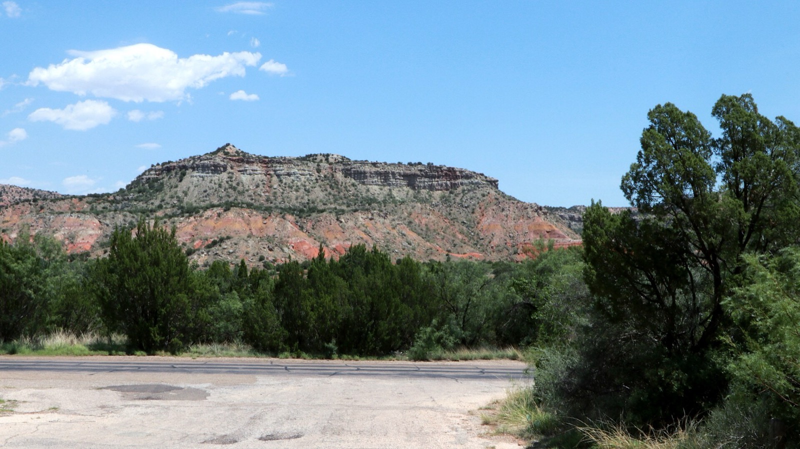 A red rock mesa above juniper scrub in Palo Duro Canyon State Park