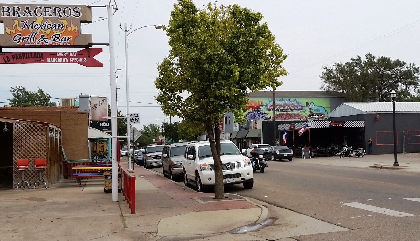 Storefronts and parked cars in the Route 66 Sixth Street Historic District